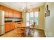 Kitchen dining area features tile floors, wood cabinets, and a large window at 41108 Calla Lily St, Fort Mill, SC 29707