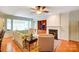 Spacious living room with a fireplace, built-in shelving, and hardwood floors at 41108 Calla Lily St, Fort Mill, SC 29707