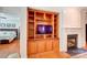 Comfortable living area with built-in shelving, a fireplace, and access to the bedroom at 41108 Calla Lily St, Fort Mill, SC 29707