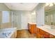 Spacious main bathroom with dual vanities, tiled floors, and separate bathtub and shower at 41108 Calla Lily St, Fort Mill, SC 29707