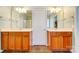 Main bathroom featuring dual wood vanities with framed mirrors and tiled floors at 41108 Calla Lily St, Fort Mill, SC 29707