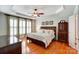 Comfortable main bedroom featuring tray ceilings, a ceiling fan, and shuttered windows for ample natural light at 41108 Calla Lily St, Fort Mill, SC 29707