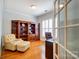 Office with wooden floors, built-in shelving and a chair and desk at 41108 Calla Lily St, Fort Mill, SC 29707