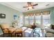 Sunroom includes ceiling fan, tile floors, and plenty of windows at 41108 Calla Lily St, Fort Mill, SC 29707