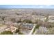Expansive aerial view of a neighborhood showcasing mature trees surrounding beautiful homes in a serene setting at 4421 Windwood Cir, Charlotte, NC 28226