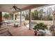 Spacious covered back porch offers views of the backyard, detached garage, and custom grill at 4421 Windwood Cir, Charlotte, NC 28226