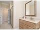 Bright bathroom featuring a walk-in shower, vanity with sink, and a framed mirror at 4421 Windwood Cir, Charlotte, NC 28226