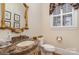 Powder room featuring a marble vanity with gold accents, ornate mirror and plantation shutters at 4421 Windwood Cir, Charlotte, NC 28226