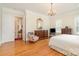 Spacious bedroom with hardwood flooring, classic furniture and a chandelier at 4421 Windwood Cir, Charlotte, NC 28226