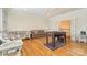 This bonus room features hardwood floors, plenty of seating, and a foosball table for all to enjoy at 4421 Windwood Cir, Charlotte, NC 28226