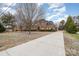 Classic brick home with an expansive driveway and meticulous landscaping at 4421 Windwood Cir, Charlotte, NC 28226