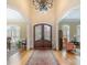 Elegant foyer with arched entryways, hardwood floors, and a stunning chandelier at 4421 Windwood Cir, Charlotte, NC 28226
