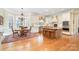 Open kitchen and dining area with a central island, stainless steel appliances, and plenty of natural light at 4421 Windwood Cir, Charlotte, NC 28226