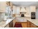 Well-lit kitchen showcasing granite countertops, custom cabinets, and stainless steel appliances at 4421 Windwood Cir, Charlotte, NC 28226