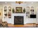 Lovely living room showcasing a fireplace with white mantel and flanking built-in shelving at 4421 Windwood Cir, Charlotte, NC 28226