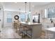 Open kitchen with island seating, white cabinets, stainless appliances and pendant lighting fixtures at 5127 Izzo Ln, Charlotte, NC 28214