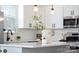 Close-up of kitchen island, quartz countertops, white subway tile backsplash and stainless steel appliances at 5127 Izzo Ln, Charlotte, NC 28214