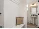 Functional mudroom with built-in bench and shelving next to a half bath with a pedestal sink at 5127 Izzo Ln, Charlotte, NC 28214