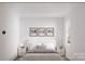 Minimalist bedroom featuring a queen bed, artwork and two matching bedside tables at 5128 Izzo Ln, Charlotte, NC 28214
