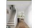 Bright, inviting hallway with hardwood floors leading to the staircase and living room at 5128 Izzo Ln, Charlotte, NC 28214