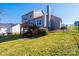 View of the home's back exterior featuring a wooden deck, a fenced yard, and manicured landscaping at 538 30Th Avenue Ne Cir, Hickory, NC 28601