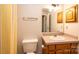 Bathroom with wood cabinets, tile countertop, and a mirror at 538 30Th Avenue Ne Cir, Hickory, NC 28601