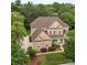 Aerial view of a brick house surrounded by trees at 561 Keystone Nw Ct, Concord, NC 28027