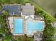 Stunning aerial view of community pool with ample seating, parking, and adjacent lake at 561 Keystone Nw Ct, Concord, NC 28027