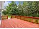 Spacious back deck with stained wood and surrounded by green foliage at 561 Keystone Nw Ct, Concord, NC 28027
