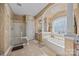 The primary bathroom features a soaking tub, glass enclosed shower, decorative column, and artistic wall accents at 561 Keystone Nw Ct, Concord, NC 28027