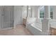 Luxurious bathroom featuring a soaking tub and separate shower at 561 Keystone Nw Ct, Concord, NC 28027