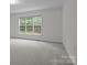Neutral bedroom with large window and plush carpet flooring at 561 Keystone Nw Ct, Concord, NC 28027