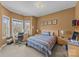 Carpeted bedroom featuring a window-side desk, striped bedding, and neutral walls at 561 Keystone Nw Ct, Concord, NC 28027
