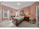 Bedroom featuring carpet, a wood-frame bed, and a large window providing natural light at 561 Keystone Nw Ct, Concord, NC 28027