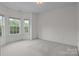 Bright bedroom with gray carpet and white walls at 561 Keystone Nw Ct, Concord, NC 28027