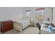 Bright bedroom with carpet floor, a bed, and two windows allowing plenty of natural light at 561 Keystone Nw Ct, Concord, NC 28027