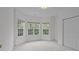 Bright bedroom featuring multiple windows and neutral carpeting at 561 Keystone Nw Ct, Concord, NC 28027