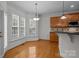Cozy breakfast nook with large windows and wood floors adjacent to kitchen at 561 Keystone Nw Ct, Concord, NC 28027