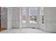 Bright room featuring a bay window, neutral carpet, and decorative molding at 561 Keystone Nw Ct, Concord, NC 28027