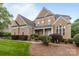Charming two-story brick home with landscaped front yard, inviting entryway, and traditional architectural details at 561 Keystone Nw Ct, Concord, NC 28027