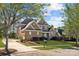 Charming brick two-story home featuring a well-manicured lawn, mature trees, and a classic design at 561 Keystone Nw Ct, Concord, NC 28027