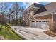 Exterior shot of a brick home with a 3-car garage and long driveway at 561 Keystone Nw Ct, Concord, NC 28027