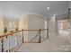 Upstairs hallway features neutral walls, white trim, and access to bedrooms and common areas at 561 Keystone Nw Ct, Concord, NC 28027