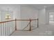 Upstairs landing featuring wooden railing and modern chandelier at 561 Keystone Nw Ct, Concord, NC 28027