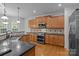 Well-equipped kitchen featuring stainless steel appliances, wooden cabinetry, and granite countertops at 561 Keystone Nw Ct, Concord, NC 28027