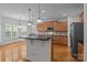 Kitchen featuring an island, stainless steel appliances, and wooden cabinetry at 561 Keystone Nw Ct, Concord, NC 28027