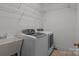 Practical laundry room equipped with modern washer and dryer at 561 Keystone Nw Ct, Concord, NC 28027