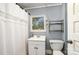 Modest bathroom with a white sink, toilet, shower, and a window providing natural light at 642 W Front St, Statesville, NC 28677