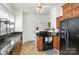 Traditional kitchen features tiled floor, granite countertops, black appliances, ceiling fan and plentiful natural light at 642 W Front St, Statesville, NC 28677