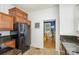 Traditional kitchen features tiled floor, granite countertops, black appliances, ceiling fan and plentiful natural light at 642 W Front St, Statesville, NC 28677
